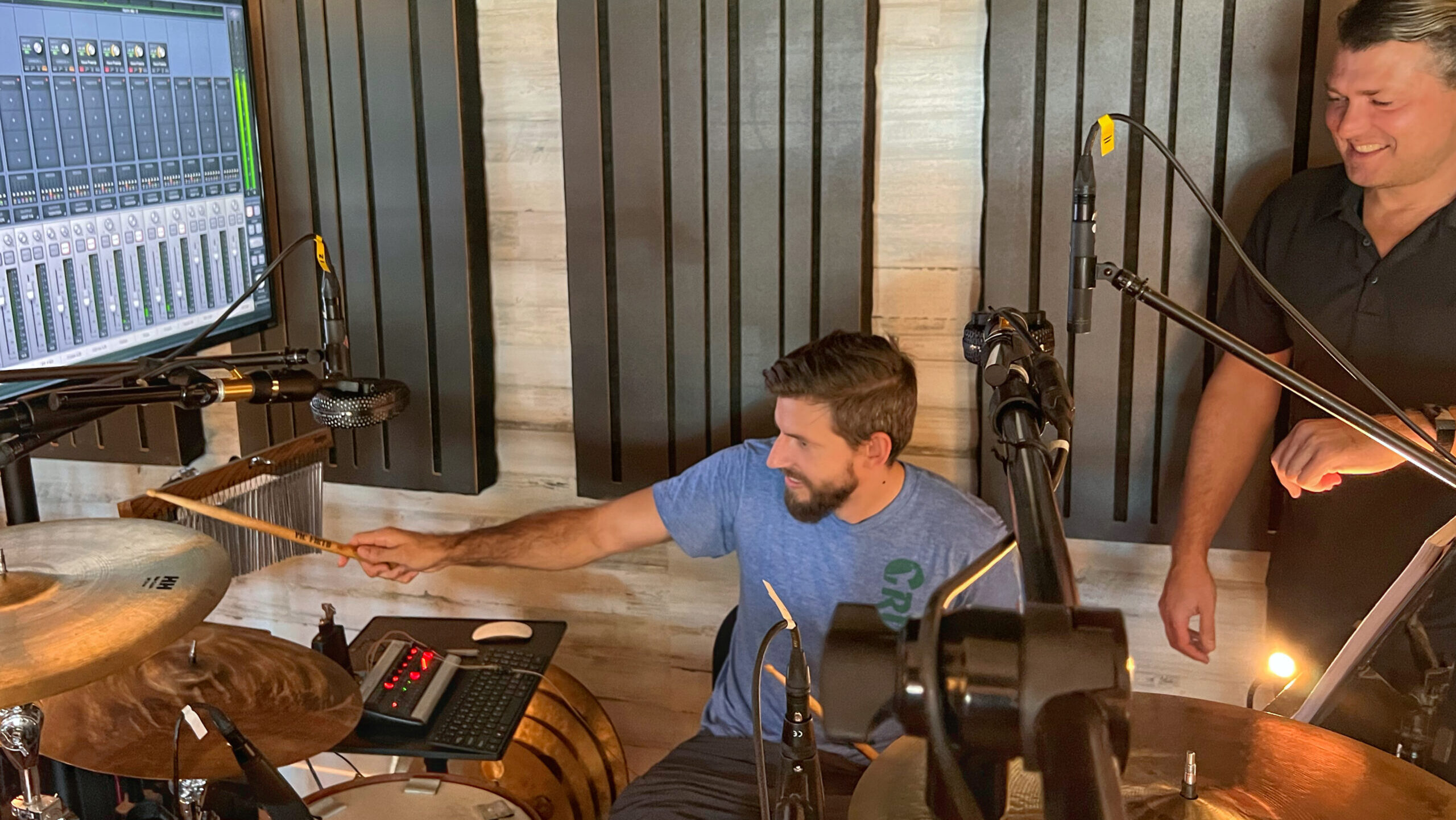 Drum student practicing on great acoustic kit as Blake Paulson coaches during a private lesson at Vose Street Sound